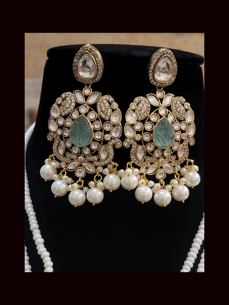 Five pearl strings kundan and AD studded set with tear drop shaped stone in the center