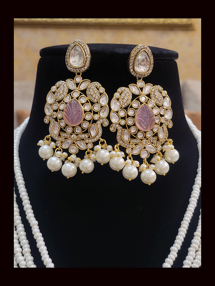 Five pearl strings kundan and AD studded set with tear drop shaped stone in the center