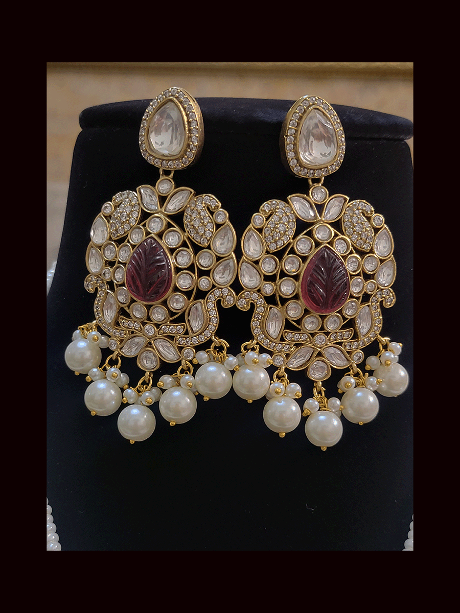 Five pearl strings kundan and AD studded set with tear drop shaped stone in the center