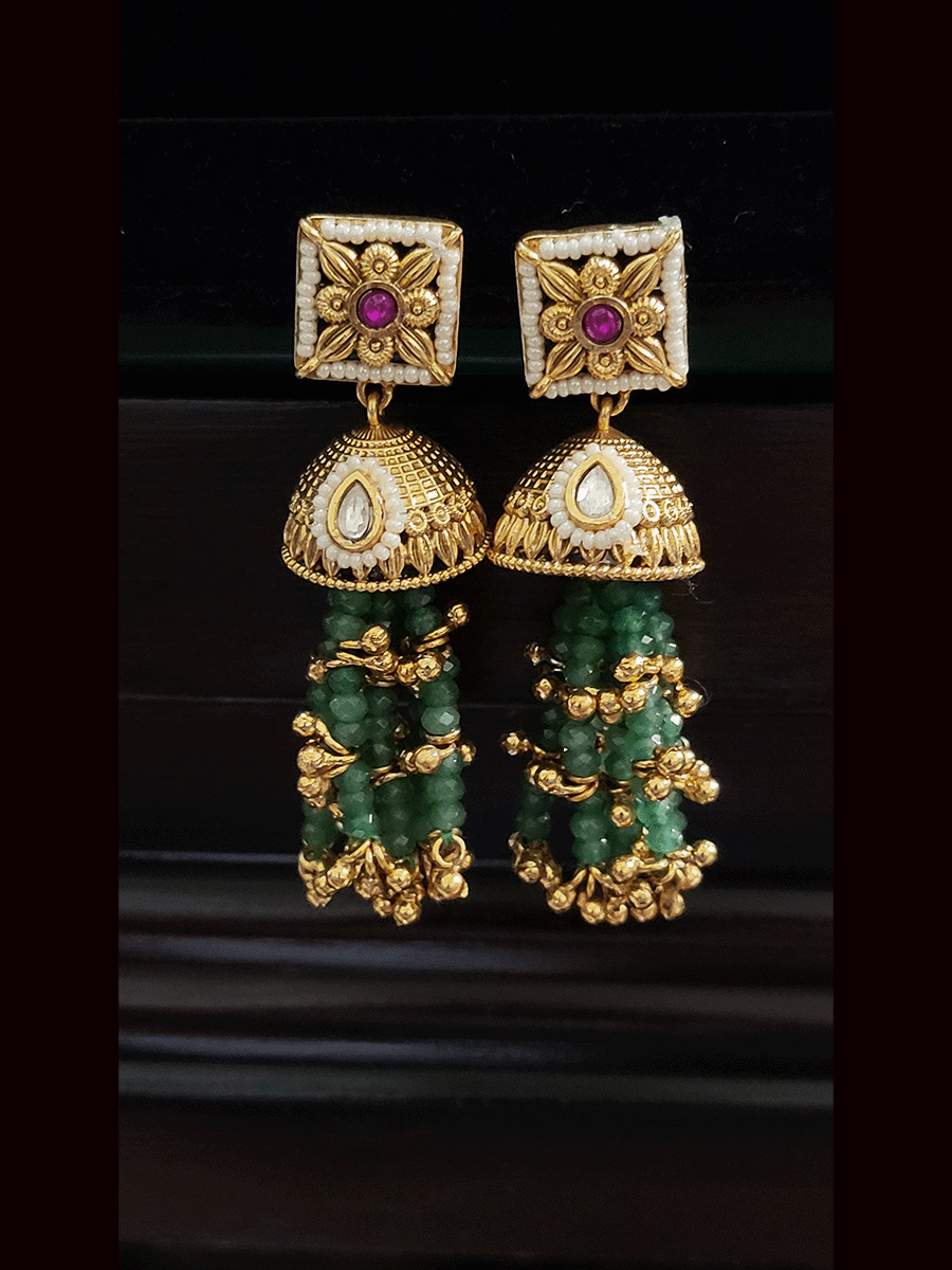 Multiple aqua strings set with ruby and kundan and white tukdies with ghunghru hangings