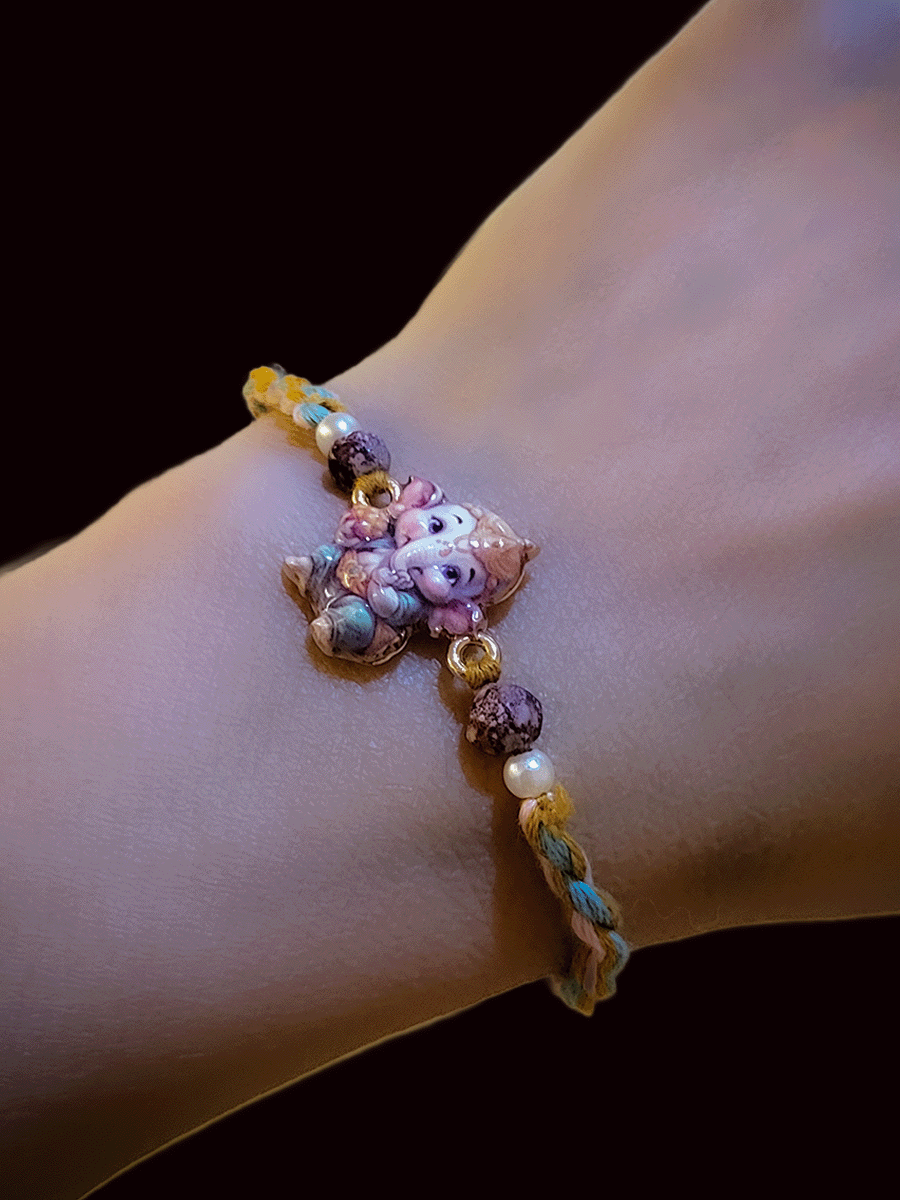 Coloured enamel bal ganpati rakhi with coloured cotton thread