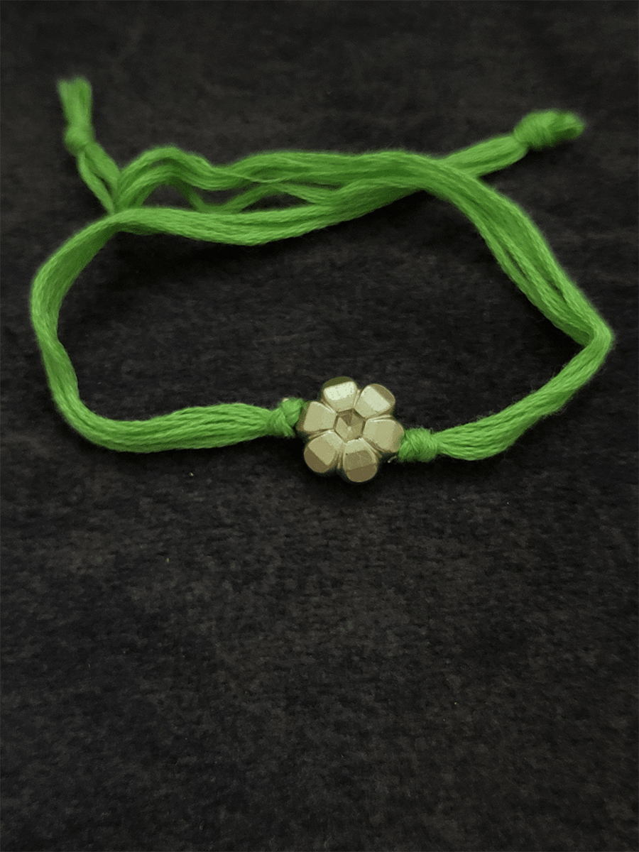 Small gold flower bead in thread rakhi - Odara Jewellery