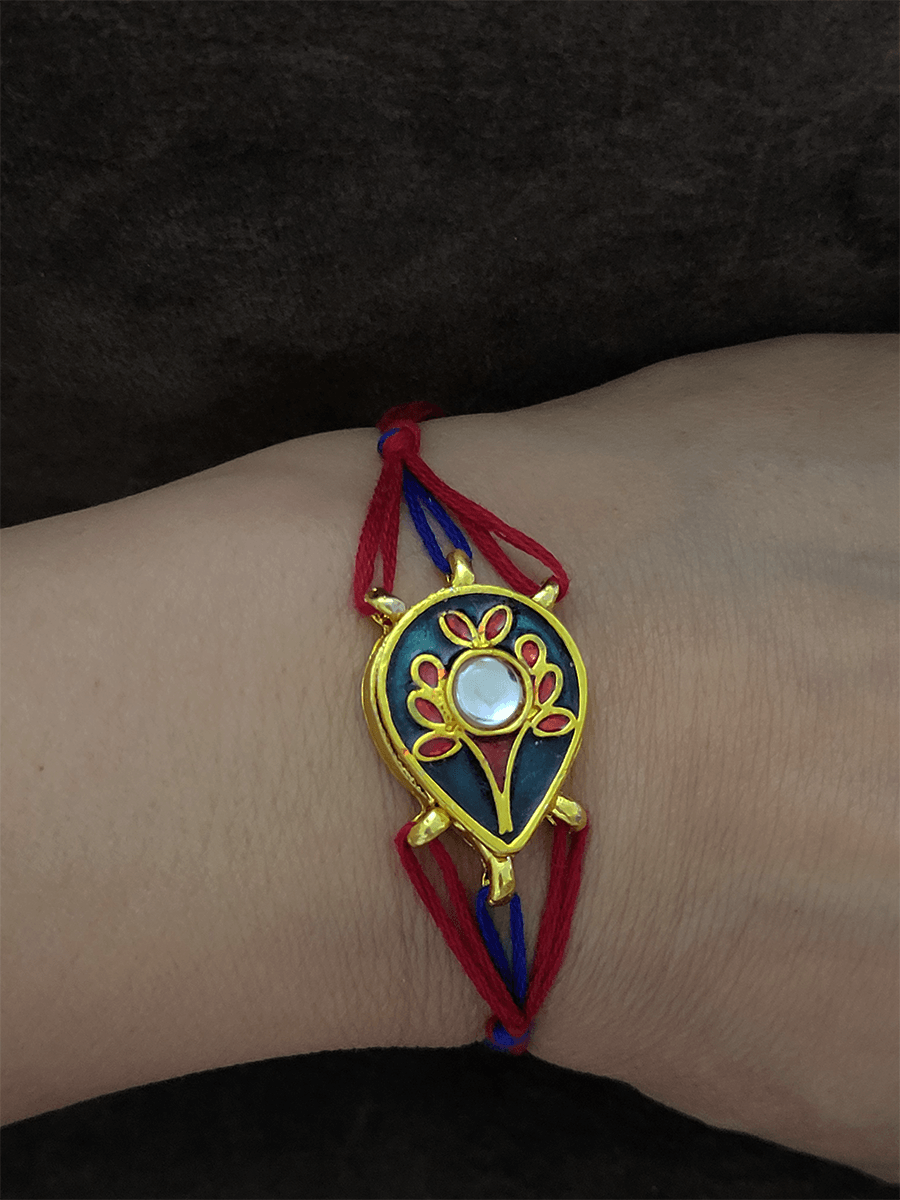 Red and blue enamel leaf shaped rakhi - Odara Jewellery