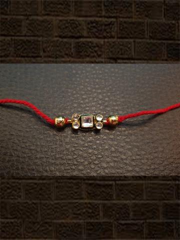 Kundan rakhi with gold bead in red thread - Odara Jewellery